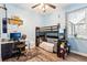 Bedroom with a bunk bed, desk, and window overlooking the backyard at 2222 Longmore Cir, Valrico, FL 33596
