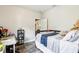 Neutral bedroom features a desk, and is staged with a single bed and blue blanket at 2222 Longmore Cir, Valrico, FL 33596