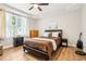 Bedroom with a queen-sized bed, side tables, dresser, and hardwood floors at 2222 Longmore Cir, Valrico, FL 33596