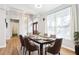 Bright dining room with a modern light fixture, table set for six, and view of the front door at 2222 Longmore Cir, Valrico, FL 33596