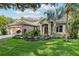 Charming single-story home featuring a well-manicured lawn, mature trees, and a welcoming two-car garage at 2222 Longmore Cir, Valrico, FL 33596