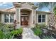 Inviting front entryway featuring a double door entry framed by meticulous landscaping at 2222 Longmore Cir, Valrico, FL 33596