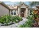 Home with a well-maintained front yard featuring lush landscaping and a paved walkway leading to the front door at 2222 Longmore Cir, Valrico, FL 33596