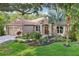 Charming home with a manicured lawn, mature trees, and inviting curb appeal at 2222 Longmore Cir, Valrico, FL 33596