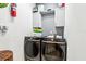 A laundry room with new front loading washer and dryer, along with white cabinets and storage at 2222 Longmore Cir, Valrico, FL 33596