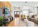 Spacious open-concept living room featuring hardwood floors, ample seating, and a decorative wall display at 2222 Longmore Cir, Valrico, FL 33596