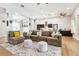 Open-concept living room with hardwood flooring, large sectional sofa, and connecting kitchen in the background at 2222 Longmore Cir, Valrico, FL 33596