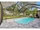 Inviting screened-in pool with brick pavers and lush landscaping for outdoor enjoyment at 2222 Longmore Cir, Valrico, FL 33596