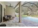 Screened-in patio area with a pool, lounge seating, and view of backyard at 2222 Longmore Cir, Valrico, FL 33596