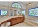 Bathroom with a large vanity, soaking tub, and decorative stained glass windows at 2413 Buckhorn Run Dr, Valrico, FL 33596