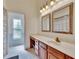 Bathroom with a vanity, double mirrors, and a doorway leading to the shower area at 2413 Buckhorn Run Dr, Valrico, FL 33596
