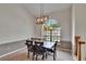 Bright dining room featuring neutral walls, carpeted floor, modern lighting, and a large arched window at 2413 Buckhorn Run Dr, Valrico, FL 33596