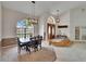 Bright dining room with a large window and modern lighting, creating a comfortable and inviting atmosphere at 2413 Buckhorn Run Dr, Valrico, FL 33596