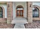 Elegant entryway with double doors and brick detailing at 2413 Buckhorn Run Dr, Valrico, FL 33596