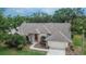 Aerial view of home showcasing mature trees, landscaping, and brick accents at 2413 Buckhorn Run Dr, Valrico, FL 33596