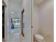 Bright hallway showcasing a sliding closet, open bedroom and a glimpse of the backyard pool at 2413 Buckhorn Run Dr, Valrico, FL 33596