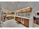 Open kitchen with stainless steel appliances, light wood cabinets, and tile flooring at 2413 Buckhorn Run Dr, Valrico, FL 33596