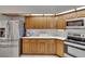 Traditional-style kitchen featuring wood cabinets, stainless steel appliances, and white countertops at 2413 Buckhorn Run Dr, Valrico, FL 33596