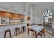Bright open space featuring a kitchen bar and a dining area with a large arched window at 2413 Buckhorn Run Dr, Valrico, FL 33596