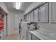 Well-organized laundry room with ample cabinet space, counter space, and modern appliances at 2413 Buckhorn Run Dr, Valrico, FL 33596