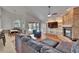 Open-concept living room with fireplace and built-ins, leading to a screened pool area at 2413 Buckhorn Run Dr, Valrico, FL 33596