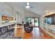 Bright living area featuring hardwood floors, vaulted ceiling, and views of the pool at 2413 Buckhorn Run Dr, Valrico, FL 33596