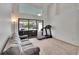 Bright living room with a gray couch, sliding glass doors to a pool area, and a treadmill at 2413 Buckhorn Run Dr, Valrico, FL 33596