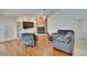 Cozy living room with brick fireplace, built-in shelving, and wood flooring at 2413 Buckhorn Run Dr, Valrico, FL 33596