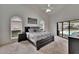 Spacious main bedroom with a vaulted ceiling, pool view, and modern decor at 2413 Buckhorn Run Dr, Valrico, FL 33596