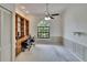 Spacious home office with custom shelving, natural light, and carpet flooring at 2413 Buckhorn Run Dr, Valrico, FL 33596