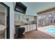 Outdoor kitchen with sink and mini-fridge at 2413 Buckhorn Run Dr, Valrico, FL 33596