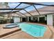 Relaxing screened-in pool with hot tub and concrete patio perfect for entertaining guests at 2413 Buckhorn Run Dr, Valrico, FL 33596