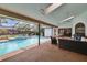 Inviting screened-in pool area with a spa, an outdoor kitchen, and patio seating at 2413 Buckhorn Run Dr, Valrico, FL 33596