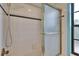 Shower has a glass door with white tile and a black accent tile at 2413 Buckhorn Run Dr, Valrico, FL 33596
