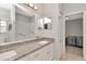 Bathroom vanity with granite counters, double sinks, and large mirror at 2823 Banyan Hill Ln, Land O Lakes, FL 34639