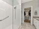 Bright bathroom with glass-enclosed shower and walk-in closet for convenient storage at 2823 Banyan Hill Ln, Land O Lakes, FL 34639