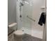 Clean bathroom with a walk-in shower featuring glass doors and a chrome showerhead at 2823 Banyan Hill Ln, Land O Lakes, FL 34639