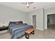 Comfortable bedroom featuring a ceiling fan, en suite bath access, and neutral wall color at 2823 Banyan Hill Ln, Land O Lakes, FL 34639