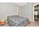 Cozy bedroom with stylish decor, neutral walls, and doorway leading to adjacent room at 2823 Banyan Hill Ln, Land O Lakes, FL 34639