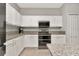 Close-up of the kitchen showcasing granite countertops and stainless steel appliances at 2823 Banyan Hill Ln, Land O Lakes, FL 34639