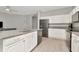 Modern kitchen with stainless steel appliances, a breakfast bar, and ample cabinet space at 2823 Banyan Hill Ln, Land O Lakes, FL 34639