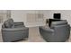 Inviting living room featuring two couches, tile floors, and large window at 2823 Banyan Hill Ln, Land O Lakes, FL 34639