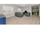 Spacious living room with neutral tones, tile flooring, and plenty of natural light at 2823 Banyan Hill Ln, Land O Lakes, FL 34639