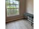 Bright office space features wood-look flooring and large window providing natural light at 2823 Banyan Hill Ln, Land O Lakes, FL 34639