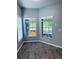 Bright room with wood-look flooring and large window showing views of outdoor space at 2823 Banyan Hill Ln, Land O Lakes, FL 34639