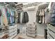 Spacious walk-in closet with ample shelving, hanging rods, and storage baskets for organization at 2823 Banyan Hill Ln, Land O Lakes, FL 34639
