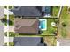 Aerial view of home with a backyard pool, a fire pit, and a meticulously landscaped yard at 34266 Radley Way, Wesley Chapel, FL 33545
