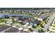 Scenic aerial view of houses near a serene lake, featuring lush greenery, well-manicured lawns, and neighborhood streets at 34266 Radley Way, Wesley Chapel, FL 33545
