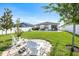 Landscaped backyard with a fire pit, Adirondack chairs, and a swimming pool at 34266 Radley Way, Wesley Chapel, FL 33545