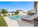 Sparkling backyard pool with lounge chairs, manicured landscaping, and privacy fence at 34266 Radley Way, Wesley Chapel, FL 33545